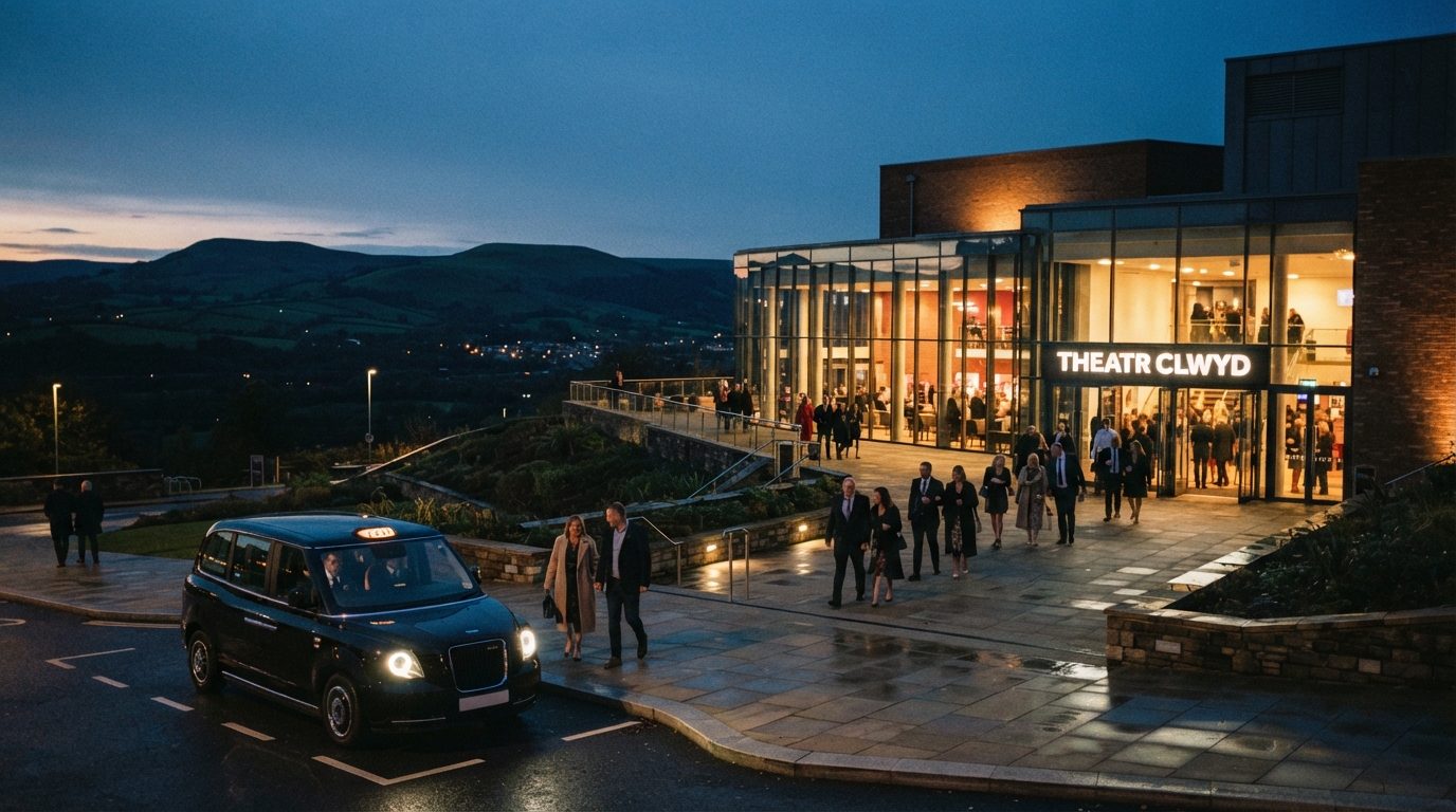 Theatr Clwyd in Mold at dusk with sleek black UK taxi cab waiting